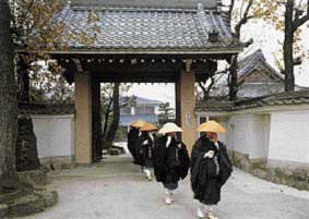 Mendicant students pass through the Main Gate.