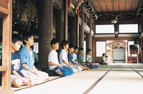 Devotees meditate with placid expressions on their faces.